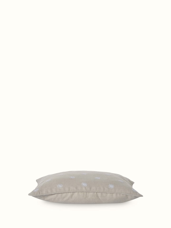 Detailed view of Rann beige buti linen Chikankari hand embroidered lumbar cushion cover focusing on the texture and design.