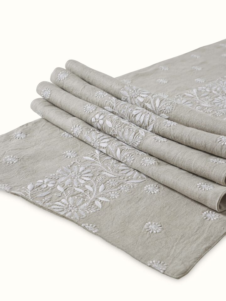 Close-up shot of hand-stitched embroidery work and fabric texture on the runner.
