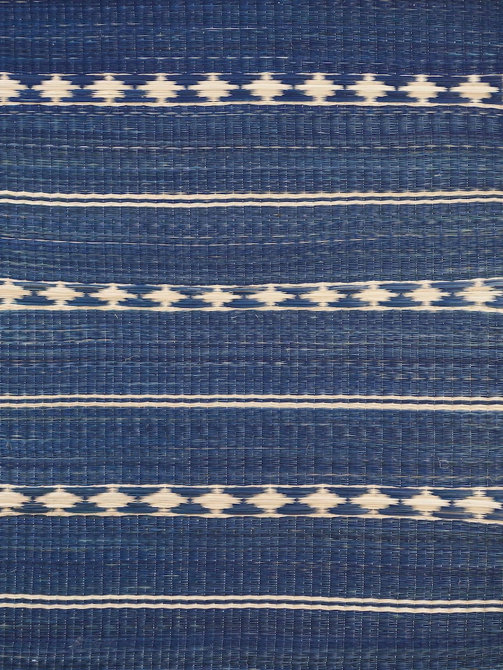 Close-up detail of Prakriti natural fibre table mat, showing fine craftsmanship and woven stripes.