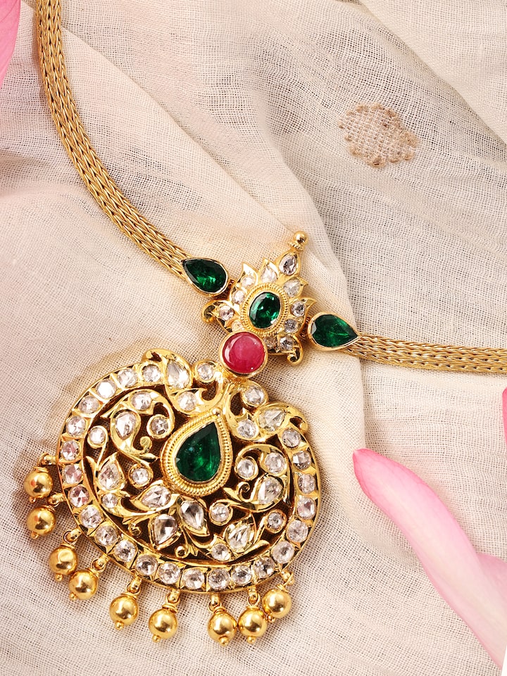 Detailed image focusing on the delicate patterns and artistry of the gold collar necklace
