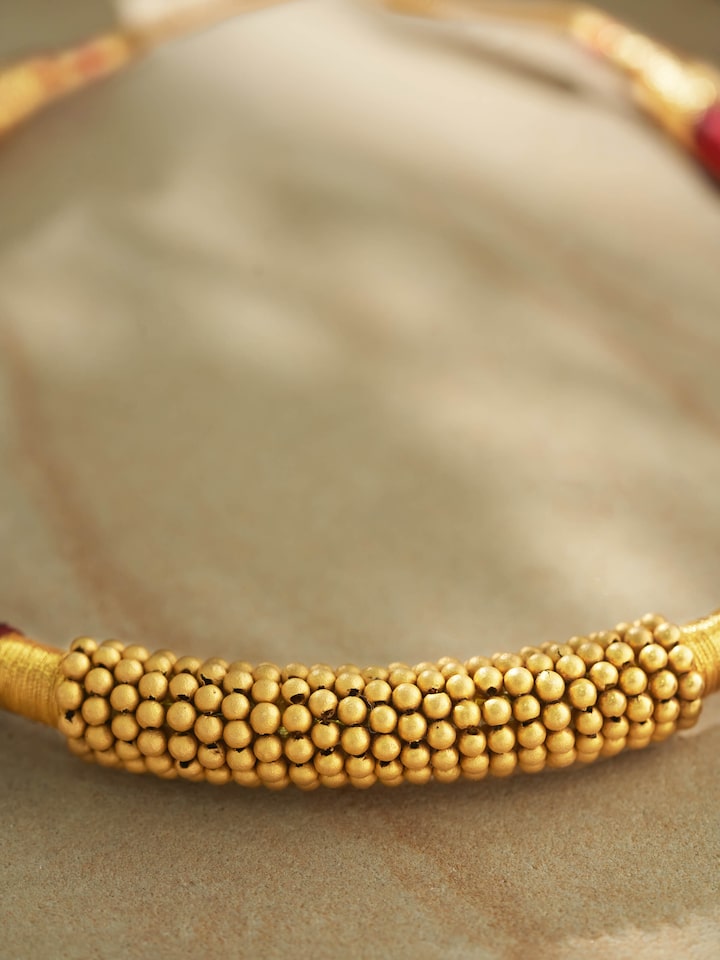 Detailed view emphasizing the intricate pattern and gold purity