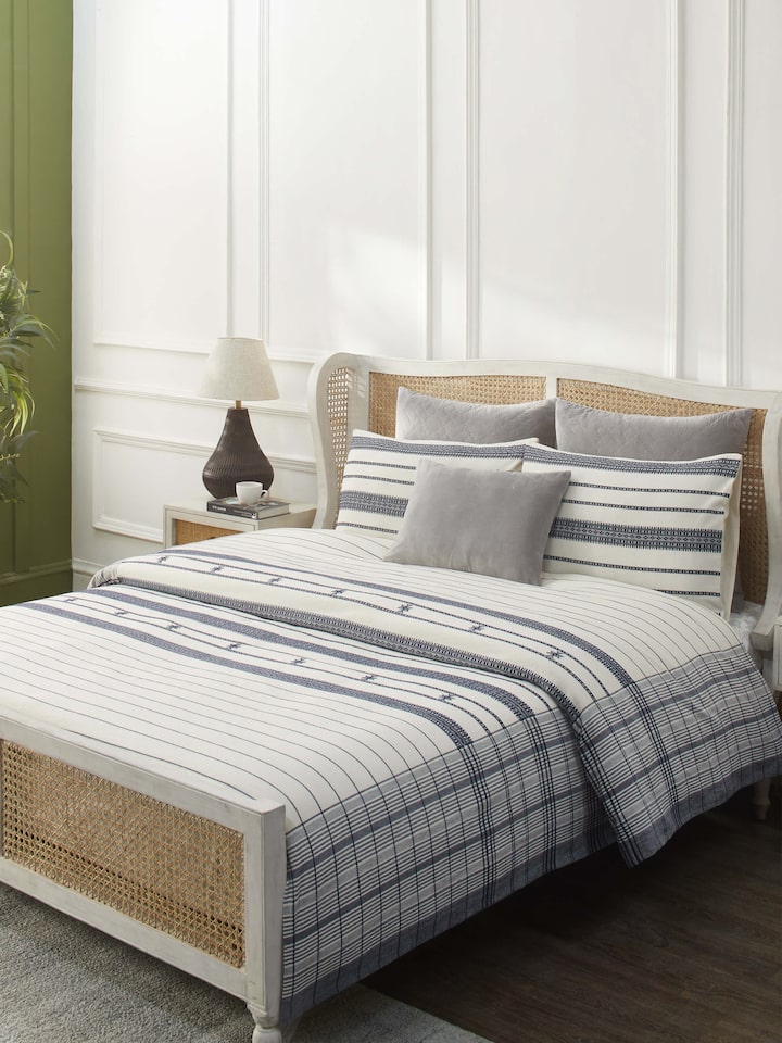 Lifestyle shot of Adalaj Blue Stripe Cotton Bhujodi Extra-Weft Queen Bedspread Set (3 pcs) on a bed.
