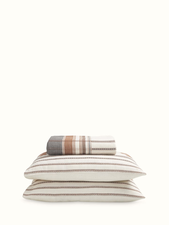 Angled view of Adalaj brown geometric cotton Bhujodi extra-weft queen bedspread set (3 pcs) showing its geometric pattern and color.