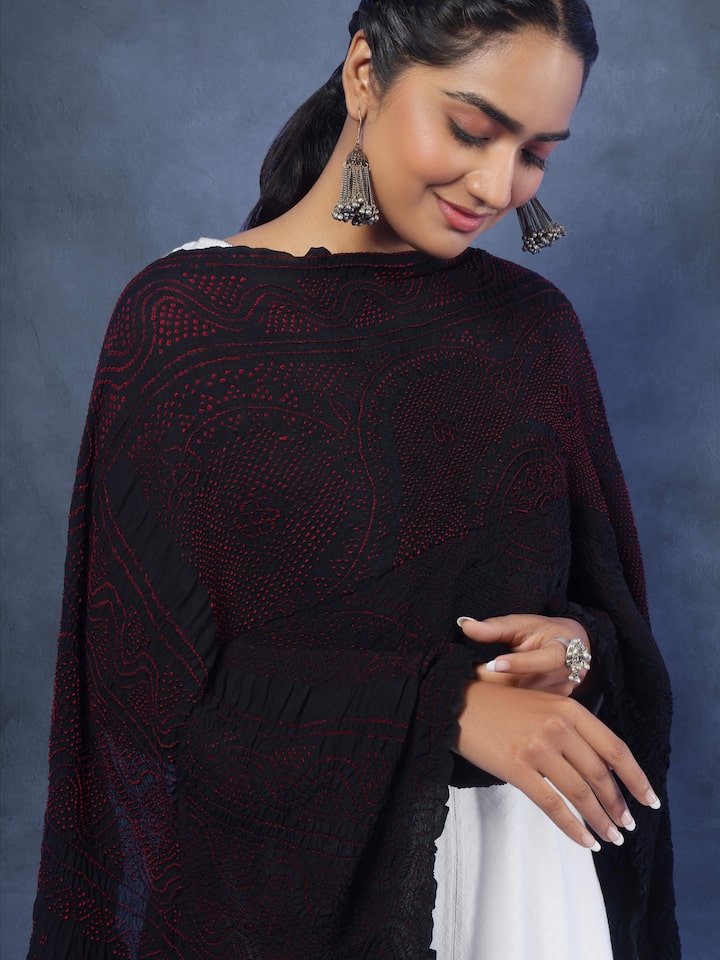 Detailed angled view of red Bandhani silk dupatta showcasing rich texture and traditional pattern.