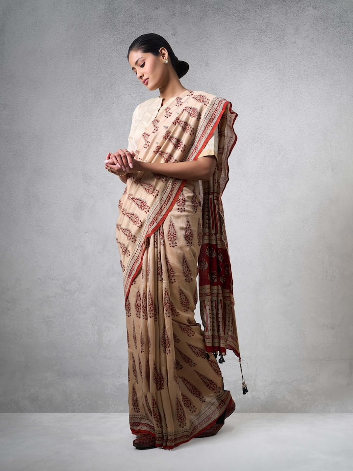 Styled view of Beige & Red Cotton Natural Dyed Bagru Block Printed Saree showing the drape styled on the shoulder