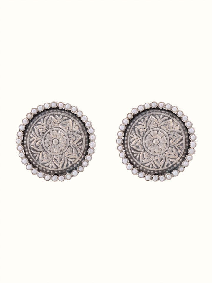 Front view of Silver Smithing stud earrings highlighting detailed silverwork and elegant design