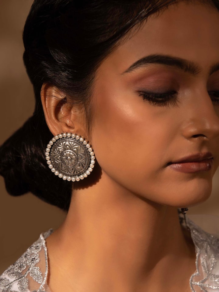 Close-up view of Silver Smithing stud earrings emphasizing intricate design and superior quality