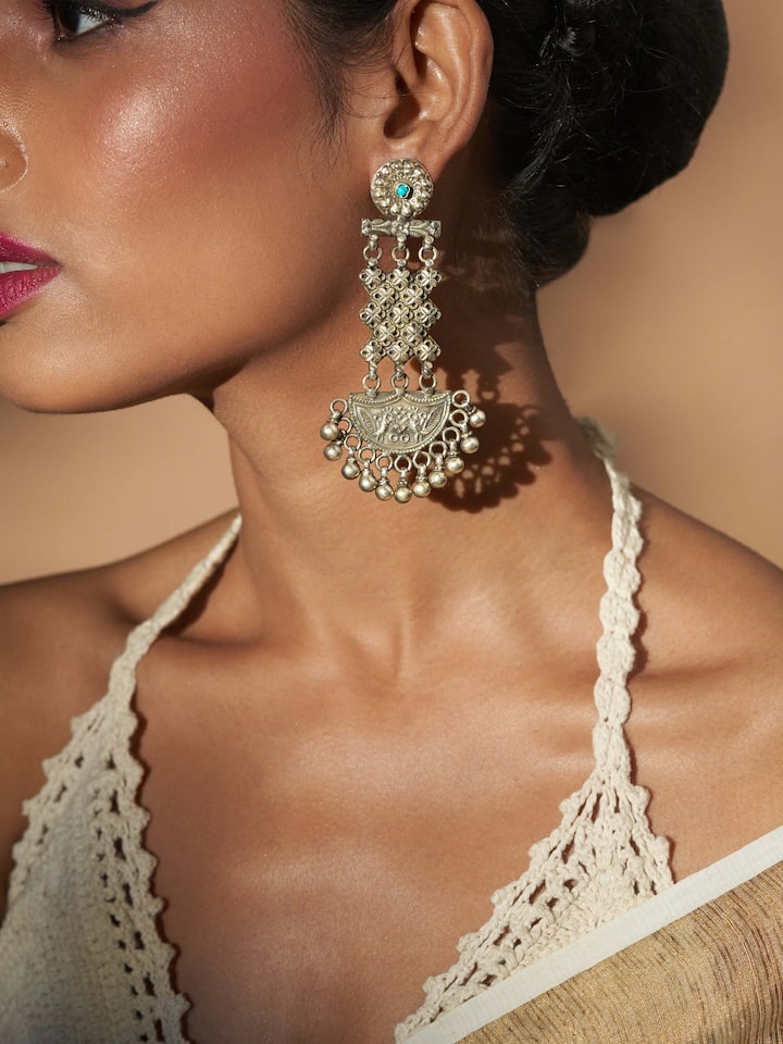 Side view of Silver Smithing Chandelier Earrings highlighting detailed silverwork and cascading design.