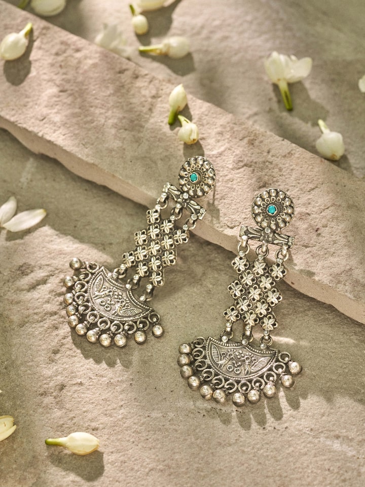 Close-up view of Silver Smithing Chandelier Earrings revealing the intricate silver detailing and chandelier elements.