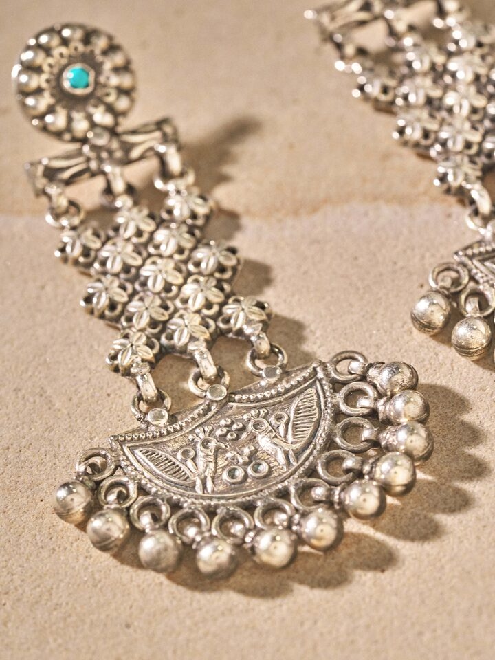 Angled view of Silver Smithing Chandelier Earrings emphasizing the elegance and detailed craftsmanship.