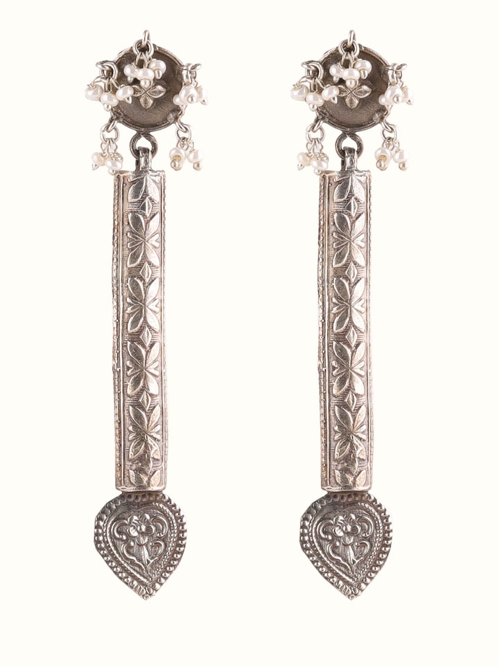 Front view of silver smithing drop earrings showcasing elegant design and detailed work.