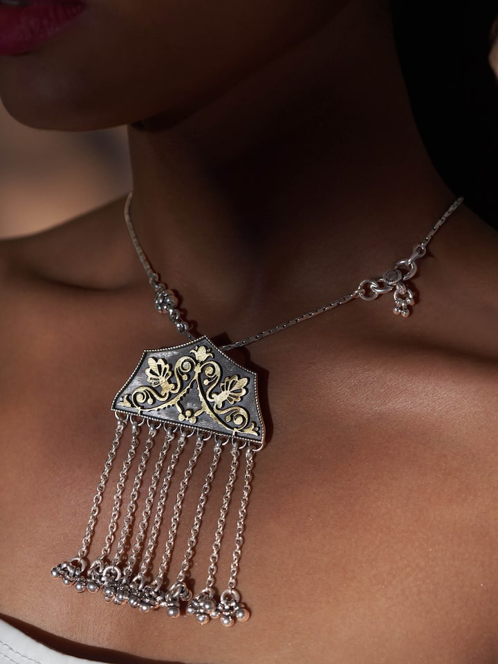 Side view of Silver Smithing Pendant highlighting the detailed silver craftsmanship and refined design.