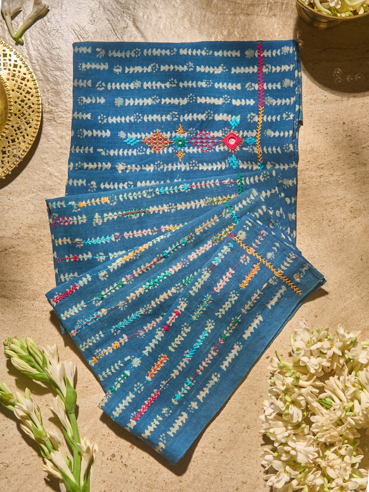 Lifestyle view showing indigo Lambani embroidered blouse fabric styled with saree