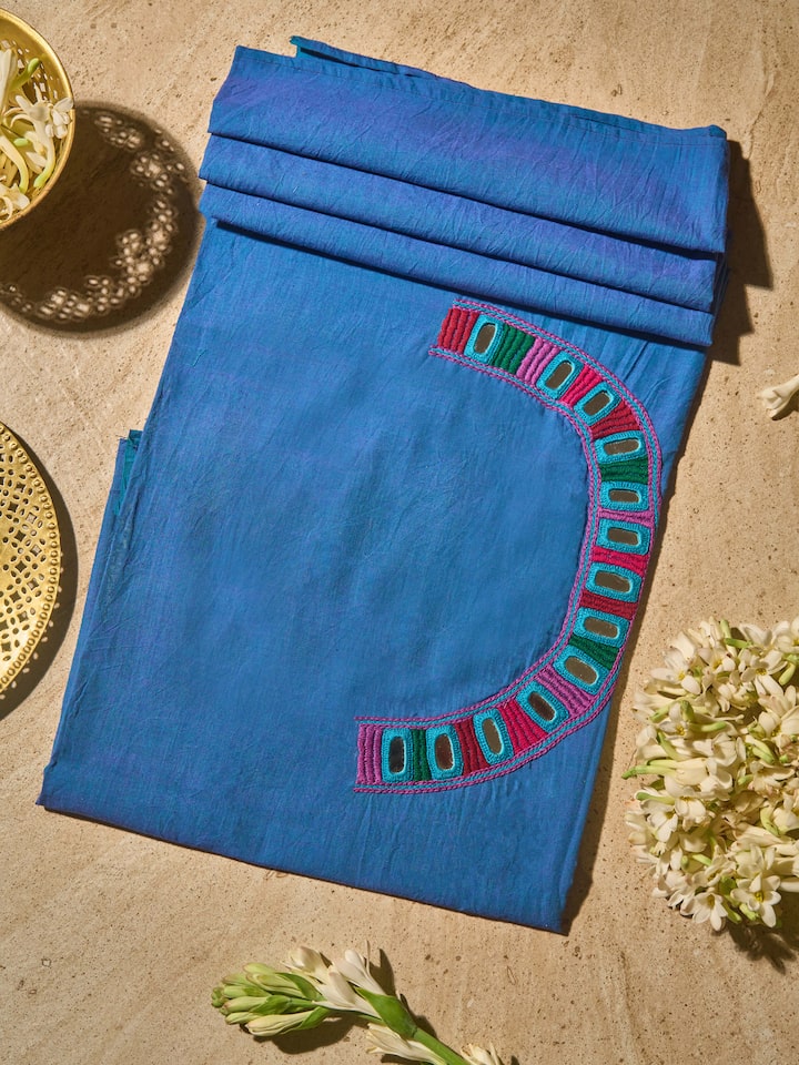 Lifestyle view showing solid blue Lambani embroidered cotton blouse fabric draped elegantly