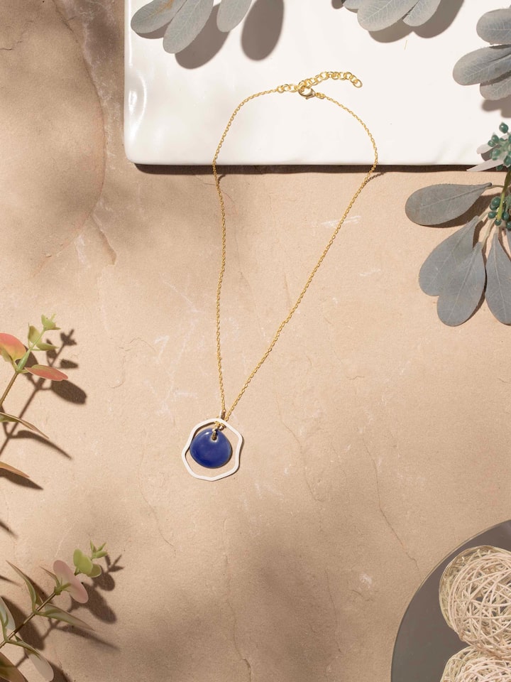 Close-up of ceramic long necklace emphasizing bead texture and color variations.