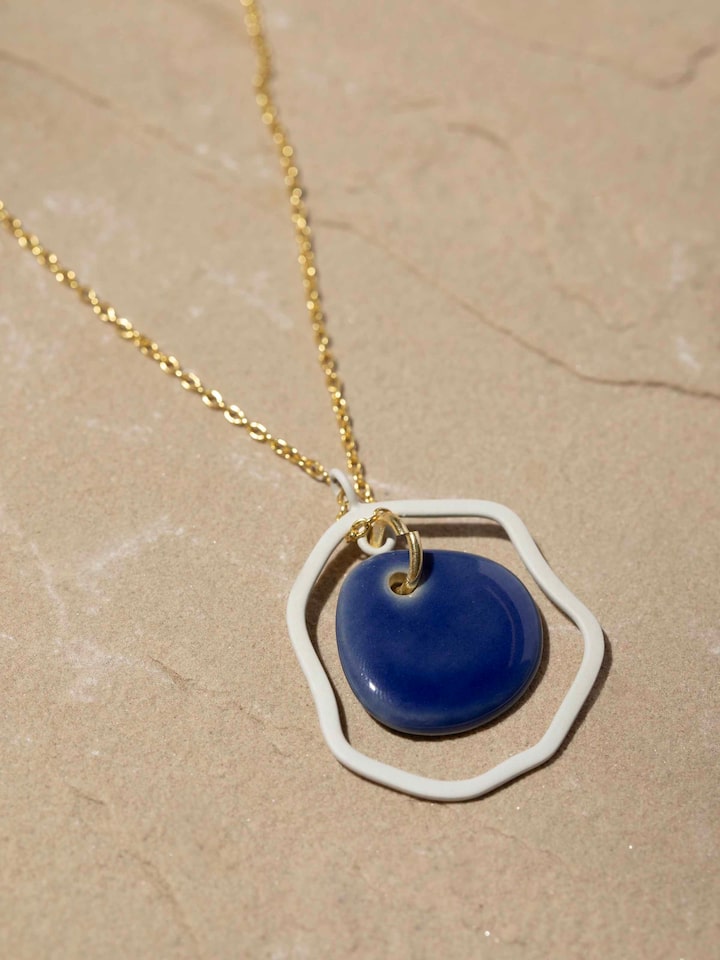 Detailed close-up of ceramic long necklace focusing on the clasp and bead arrangement.