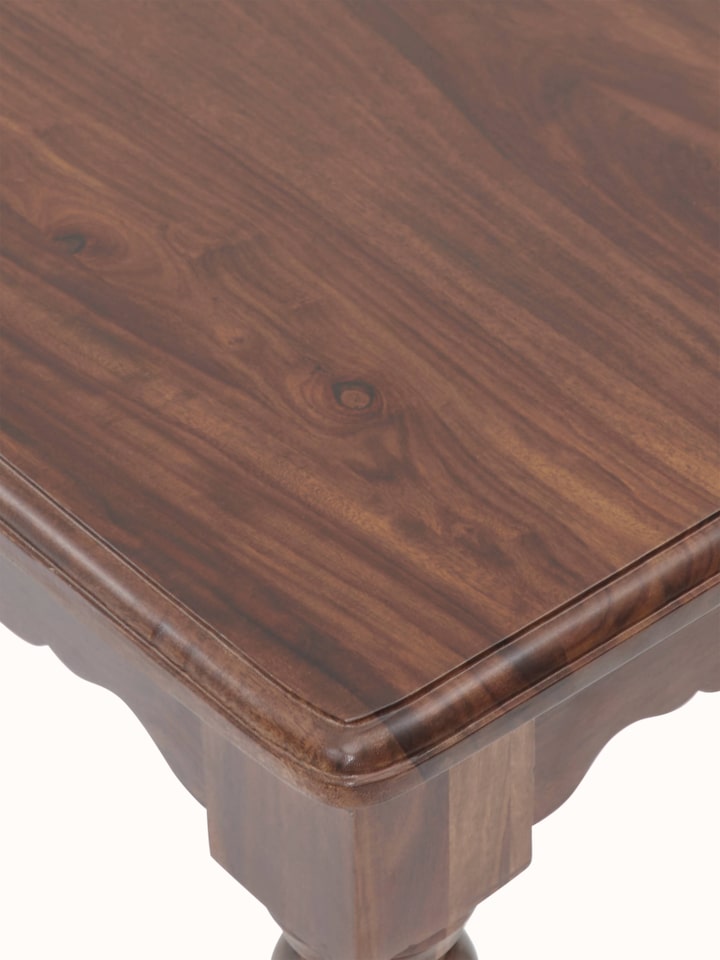 Detailed view of the Sheesham wood dining table's surface, highlighting the natural wood patterns and finish.