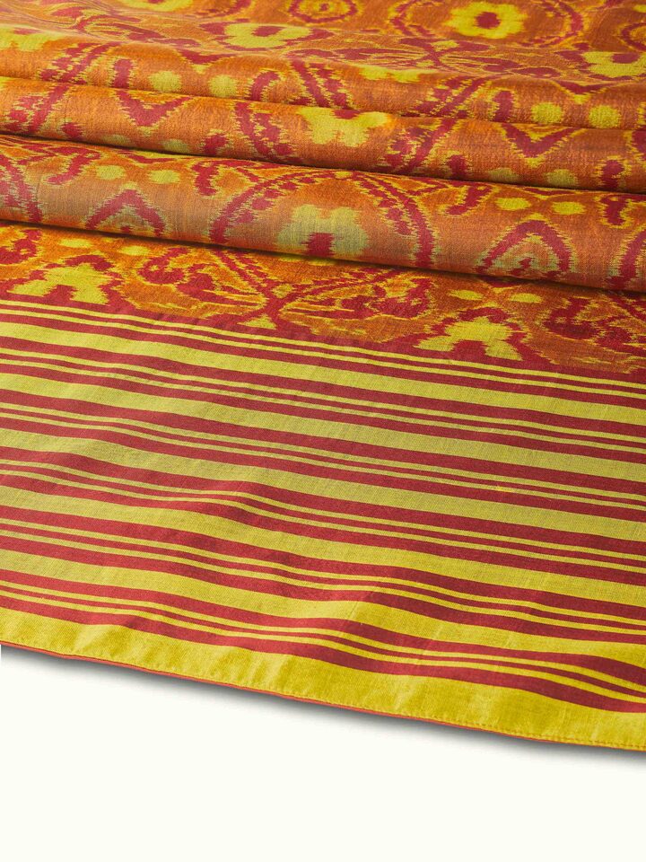Detail view highlighting handwoven silk texture and color precision in Bhoomi red Ikat bed runner