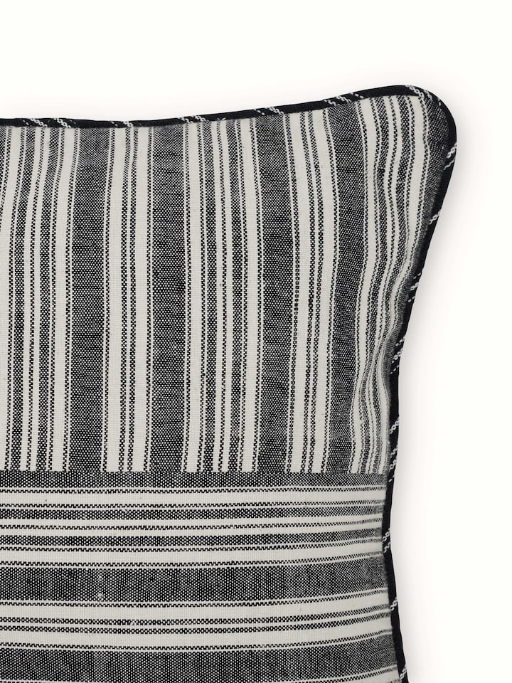 Detailed close-up of Krsna black kaza cotton handloom cushion cover emphasizing the handloom craftsmanship and fabric texture.