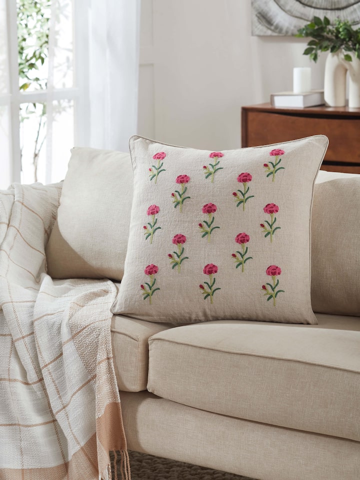 Close-up view of Mughal miniature magenta buti linen crewel hand embroidered cushion cover, showcasing detailed hand embroidery in magenta.