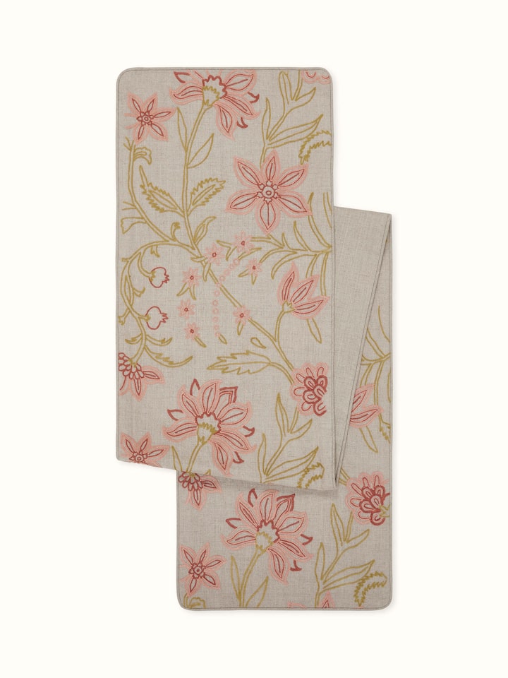 Front view of peach linen table runner with intricate all-over Kashmiri chain stitch embroidery.