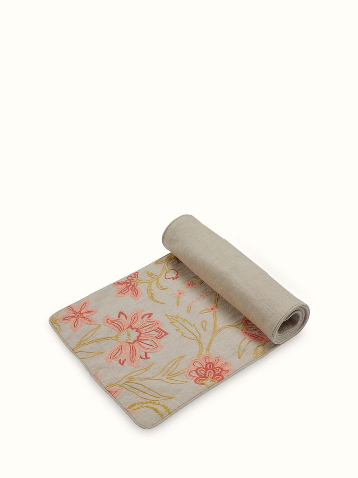 Angled view of runner emphasizing the flow and detailed embroidery from one end.