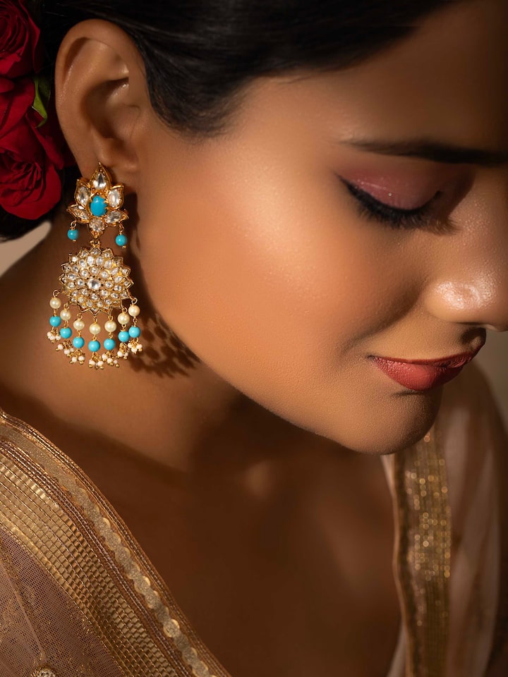 Side view of Bandhel metal drop earrings showcasing detailed metalwork and design