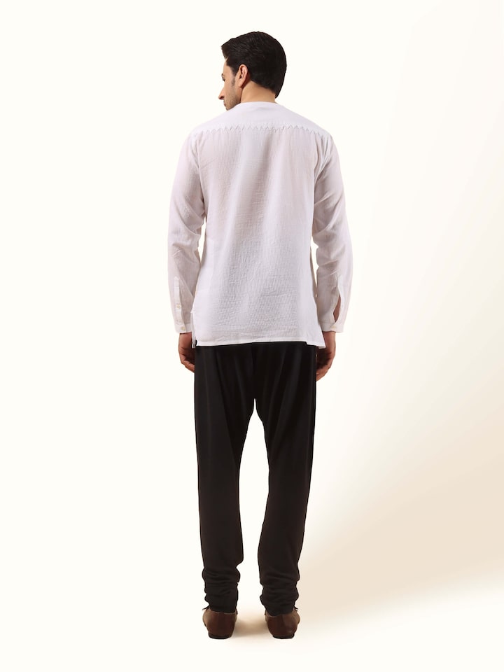 Back view of black churidar highlighting clean seam and body-contouring silhouette.
