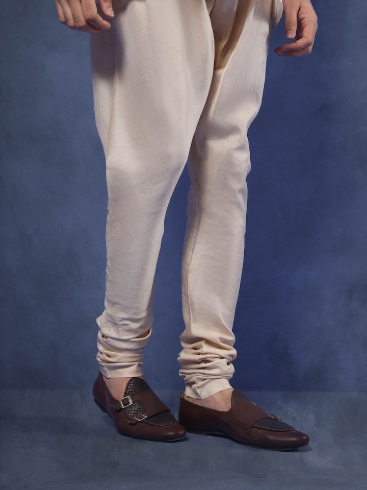 Angled view capturing the fit and natural drape of the Tussar silk churidar.