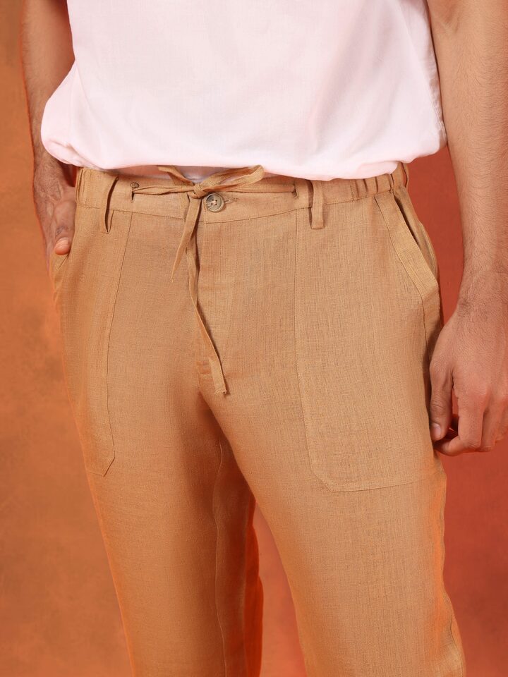 Detail shot highlighting elastic waistband and breathable linen weave of beige lounge pant