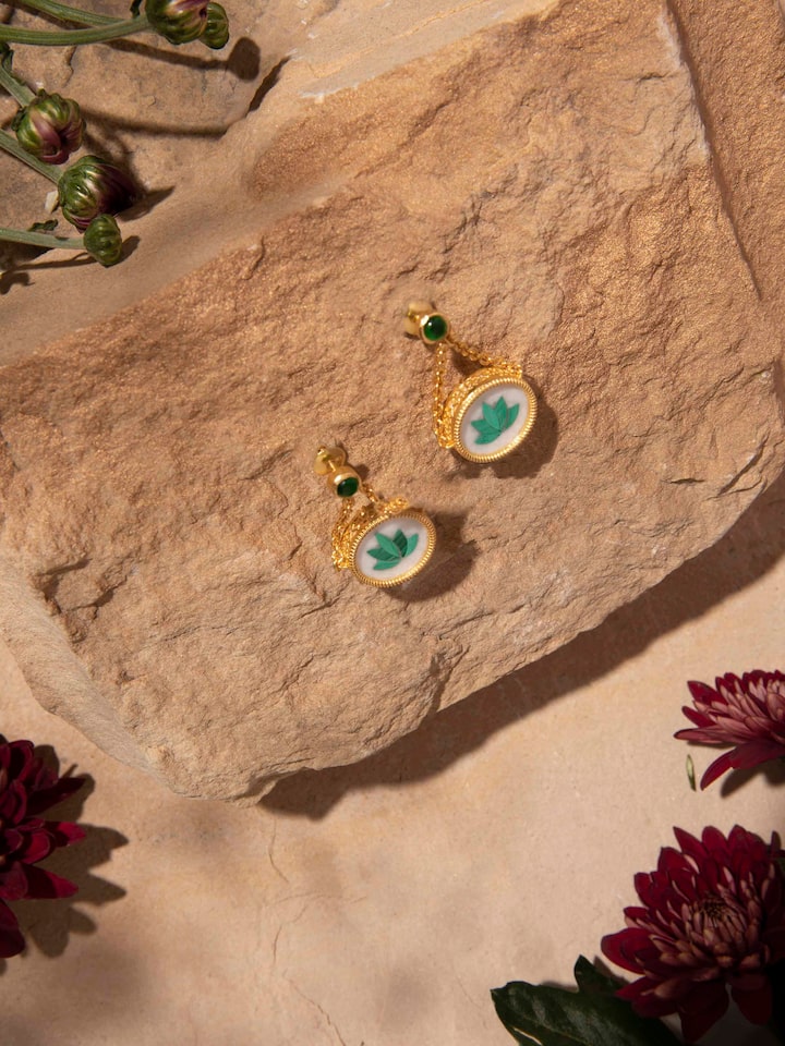 Close-up of Pacchikari silver drop earrings focusing on the intricate detailing and traditional design elements.