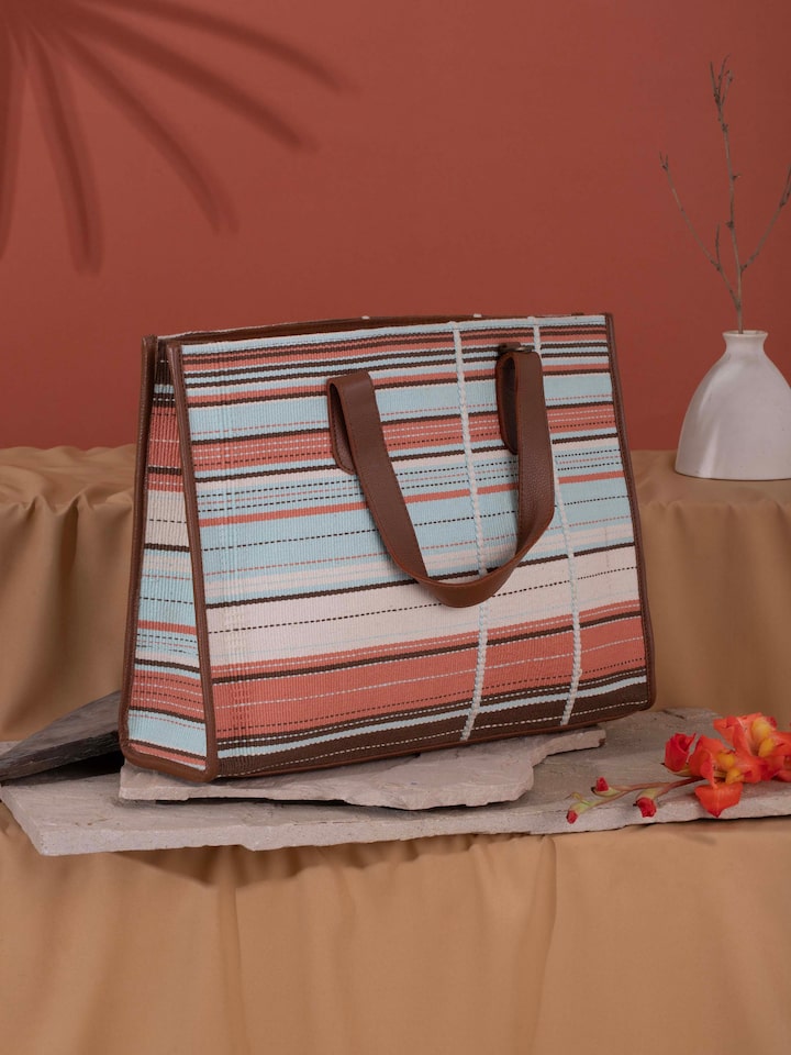 Side view of multicolor leather & textile Nagaland loin loom tote bag highlighting detailed craftsmanship
