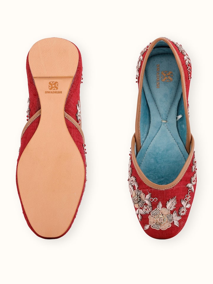 Back view of maroon leather zardozi juttis displaying the heel and overall design