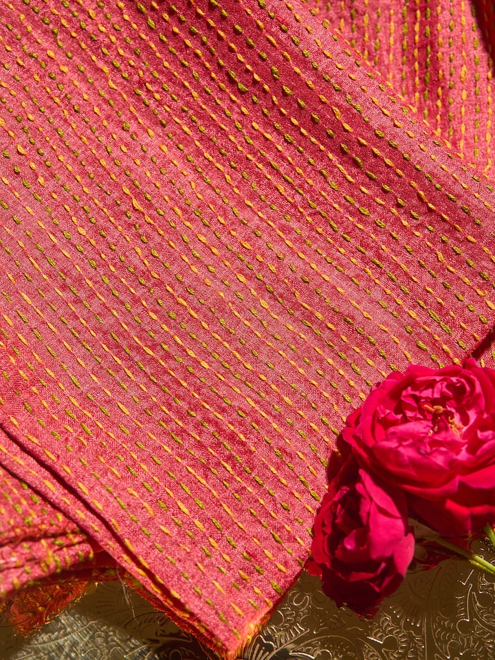Diagonal view highlighting the sleeve and neckline embroidery.