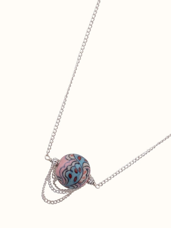 Angled view of Ceramic Long Necklace showcasing its elegant design and ceramic detailing.
