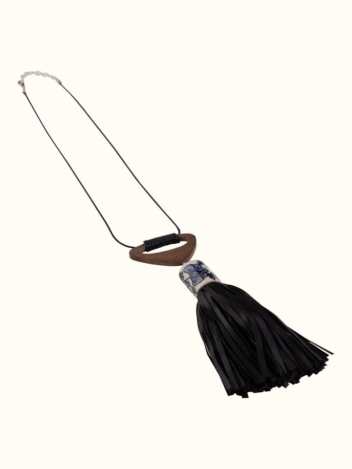 Angled view of ceramic long necklace highlighting its intricate design and craftsmanship