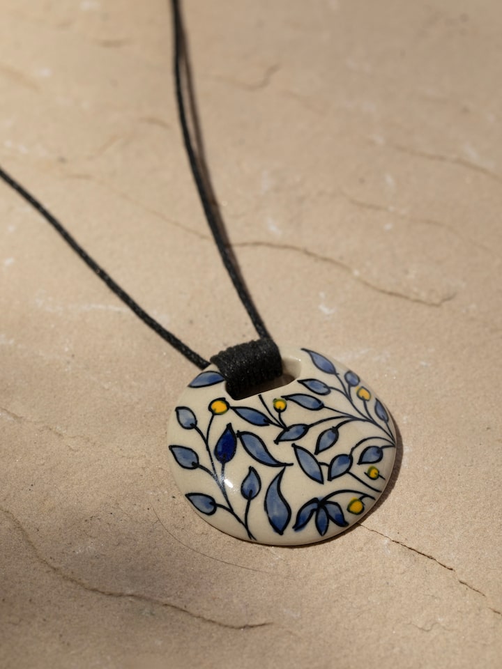 Detail view of Ceramic Pendant & Chain highlighting the stone setting and metalwork detail
