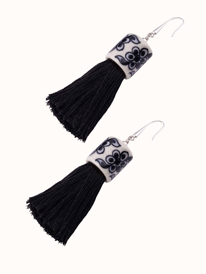 Overhead view of Ceramic Drop Earrings highlighting the elegant shape and ceramic finish.