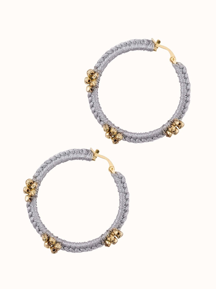 Angled view of Zari Patwa hoop earrings showcasing their stylish and traditional appeal