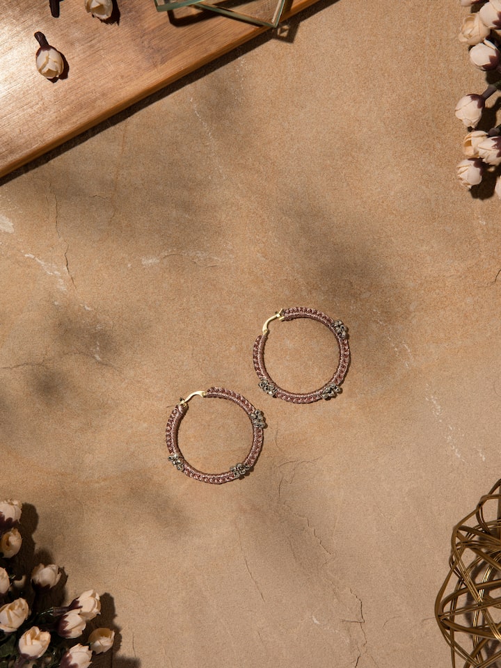 Side angle showing the delicate hoop shape and detailed craftsmanship of the earrings