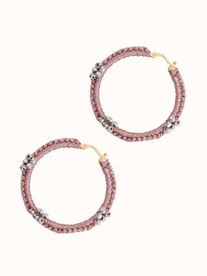 Artistic overhead shot focusing on the elegant design and shine of the hoop earrings