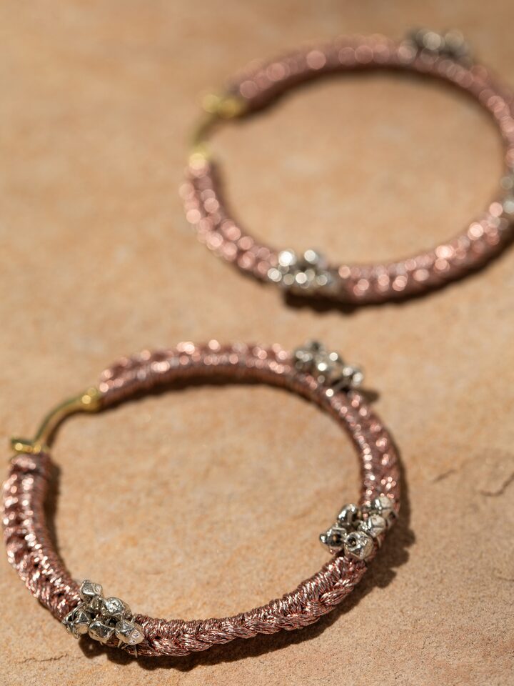 Close-up highlighting the fine zari work and smooth texture on the hoop surface