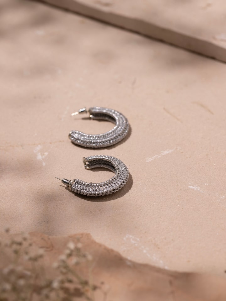 Detailed view of Zari Patwa hoop earrings illustrating their intricate design and traditional craftsmanship.