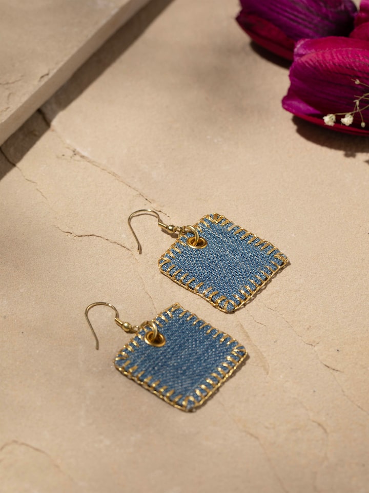 Styled detail view of Upcycled Drop Earrings worn on the ear, shown in another styled shot