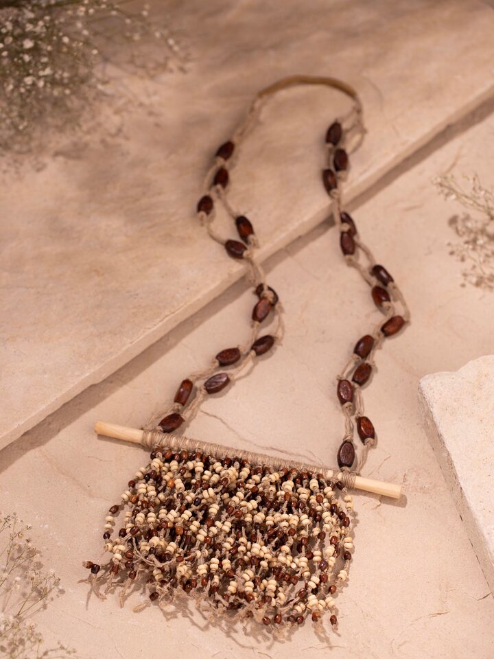 Side view of Jute Long Necklace highlighting its length and natural texture.