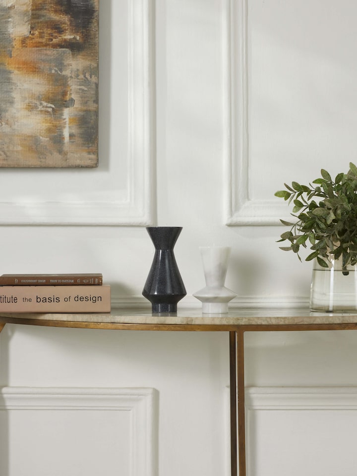 Close-up of carved black marble candle holders, showcasing their detailed craftsmanship and smooth finish.