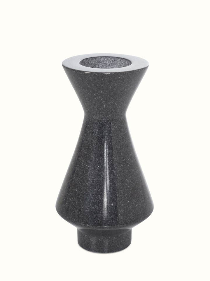 Side view of carved black marble candle holders, highlighting the elegant design and detailing.