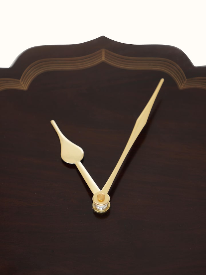 Close-up view of Handcrafted Tarkashi Sheesham Wood & Brass Wall Clock, focusing on the wood grain and brass details