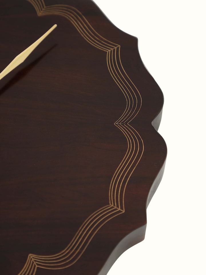 Angled view of Handcrafted Tarkashi Sheesham Wood & Brass Wall Clock, emphasizing the clock face and wood frame