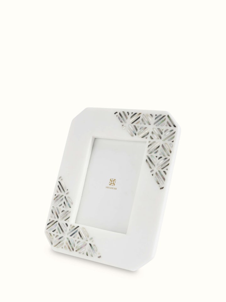 Close-up view of Pacchikari marble photo frames in white color focusing on marble quality and finish